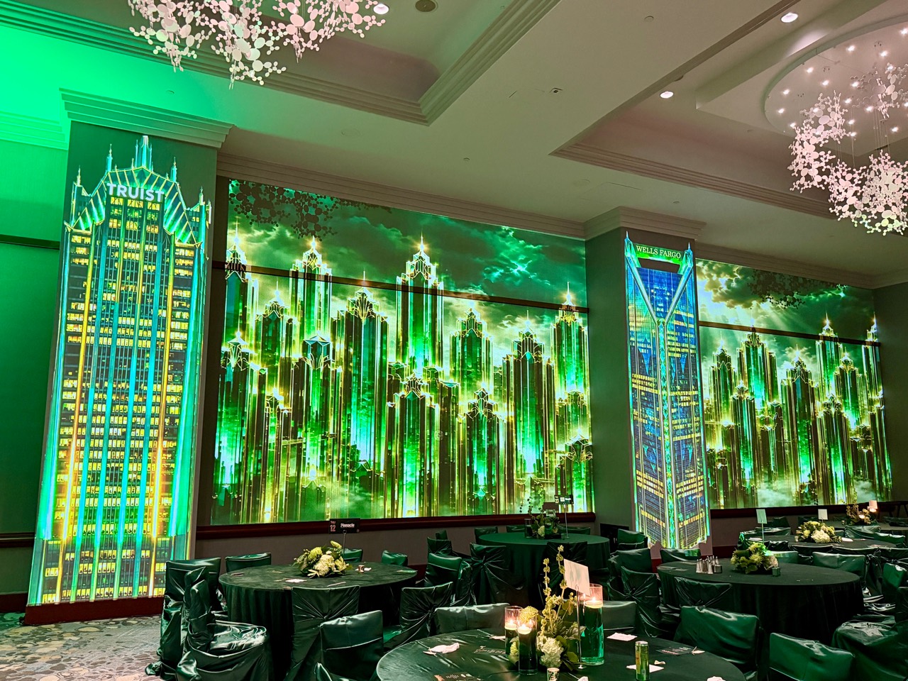 An emerald skyline across ballroom walls and columns
