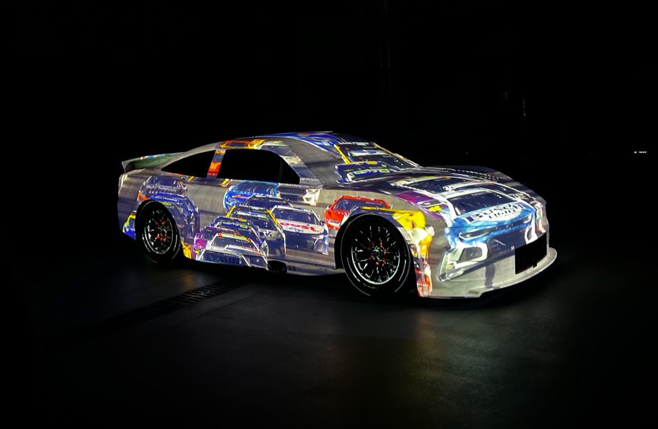 A race car wrapped in detailed projected graphics