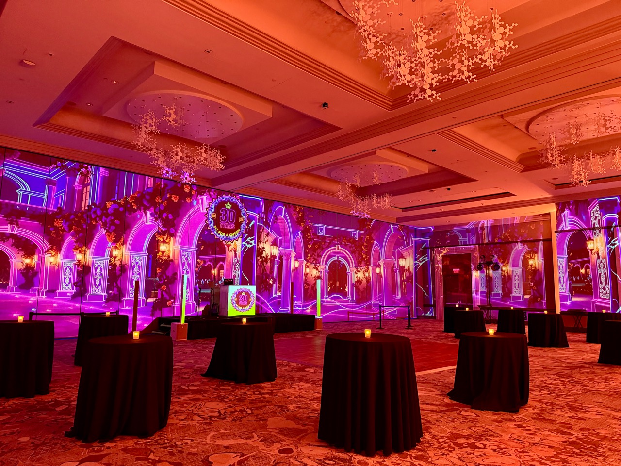 A ballroom transformed with magenta architectural visuals