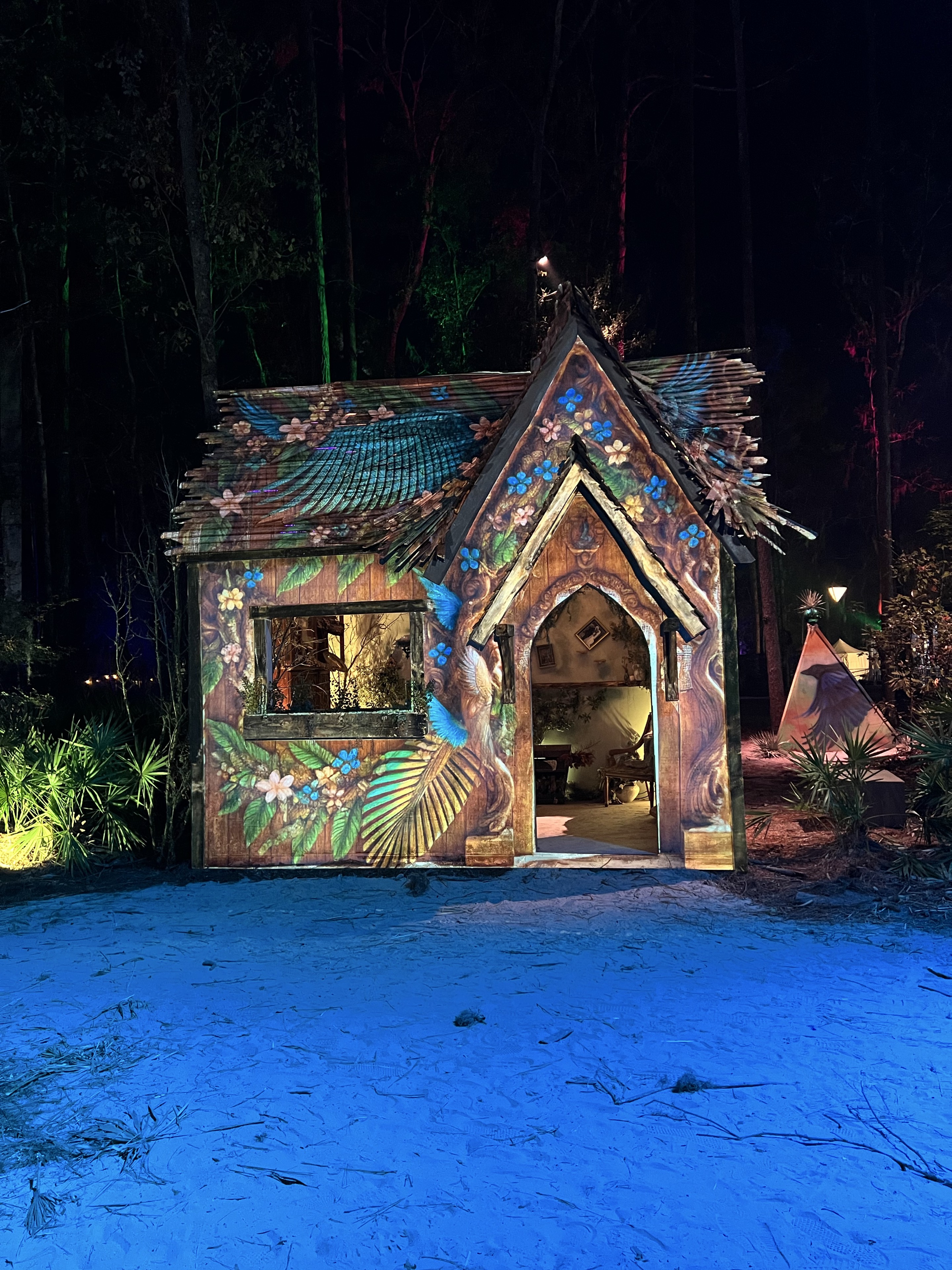 Floral projection on a woodland cottage