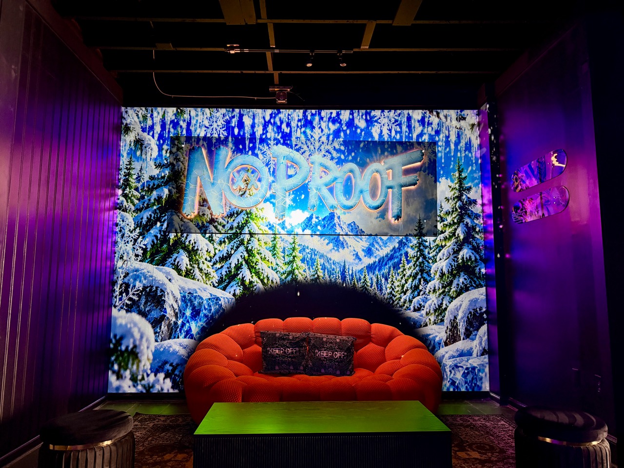 Winter forest visuals behind the No Proof lounge seating